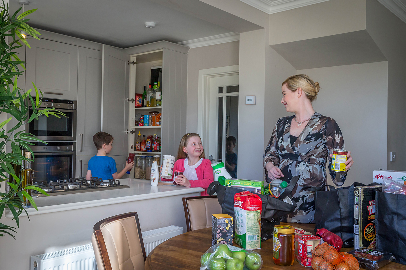 Mum With Kids Packing Shopping in Kitchen - Family Lifestyle Photography © David Cantwell Photography