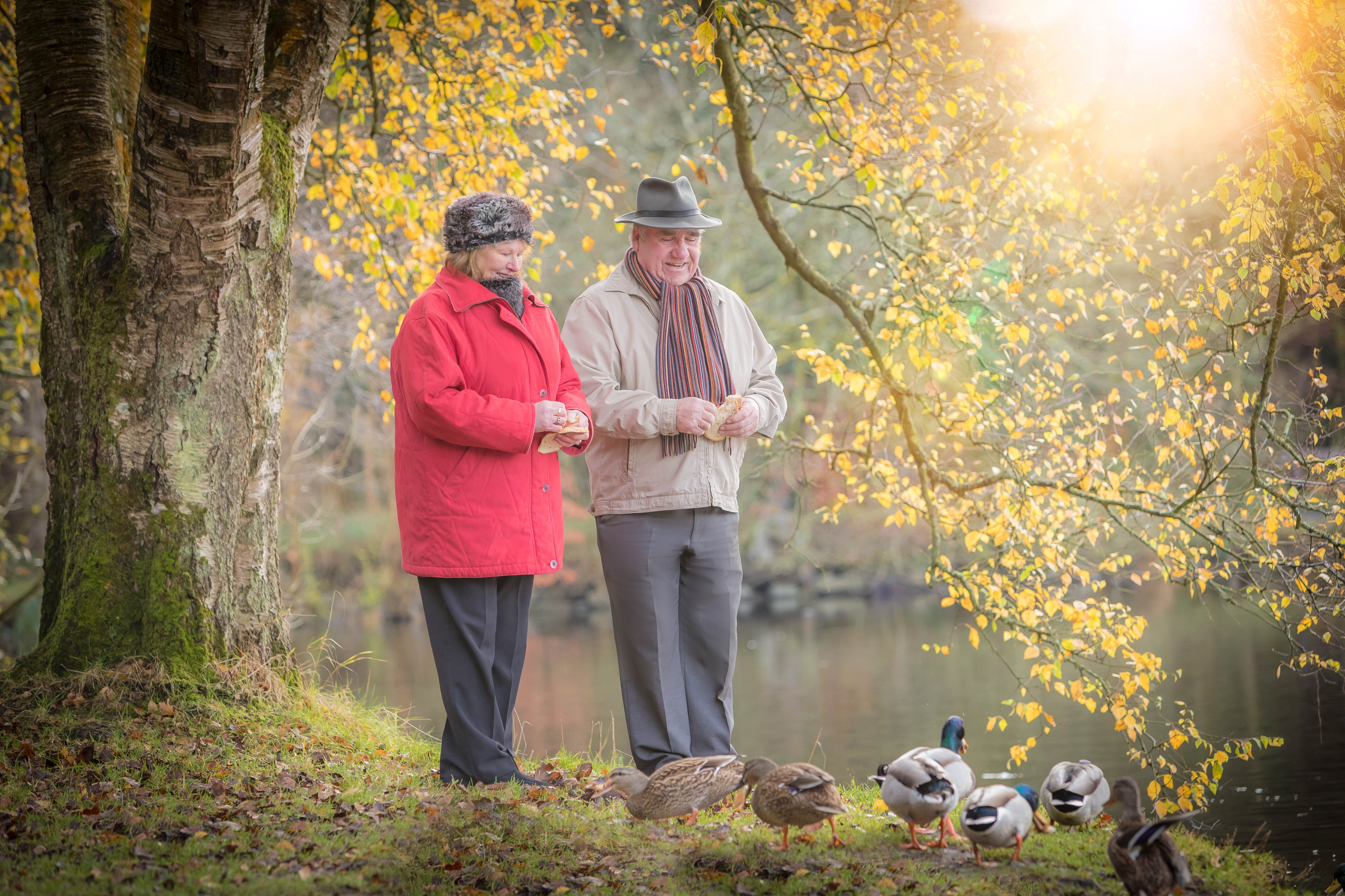 Older Couple Feeding Ducks in Park - Couple Lifestyle Photography © David Cantwell Photography