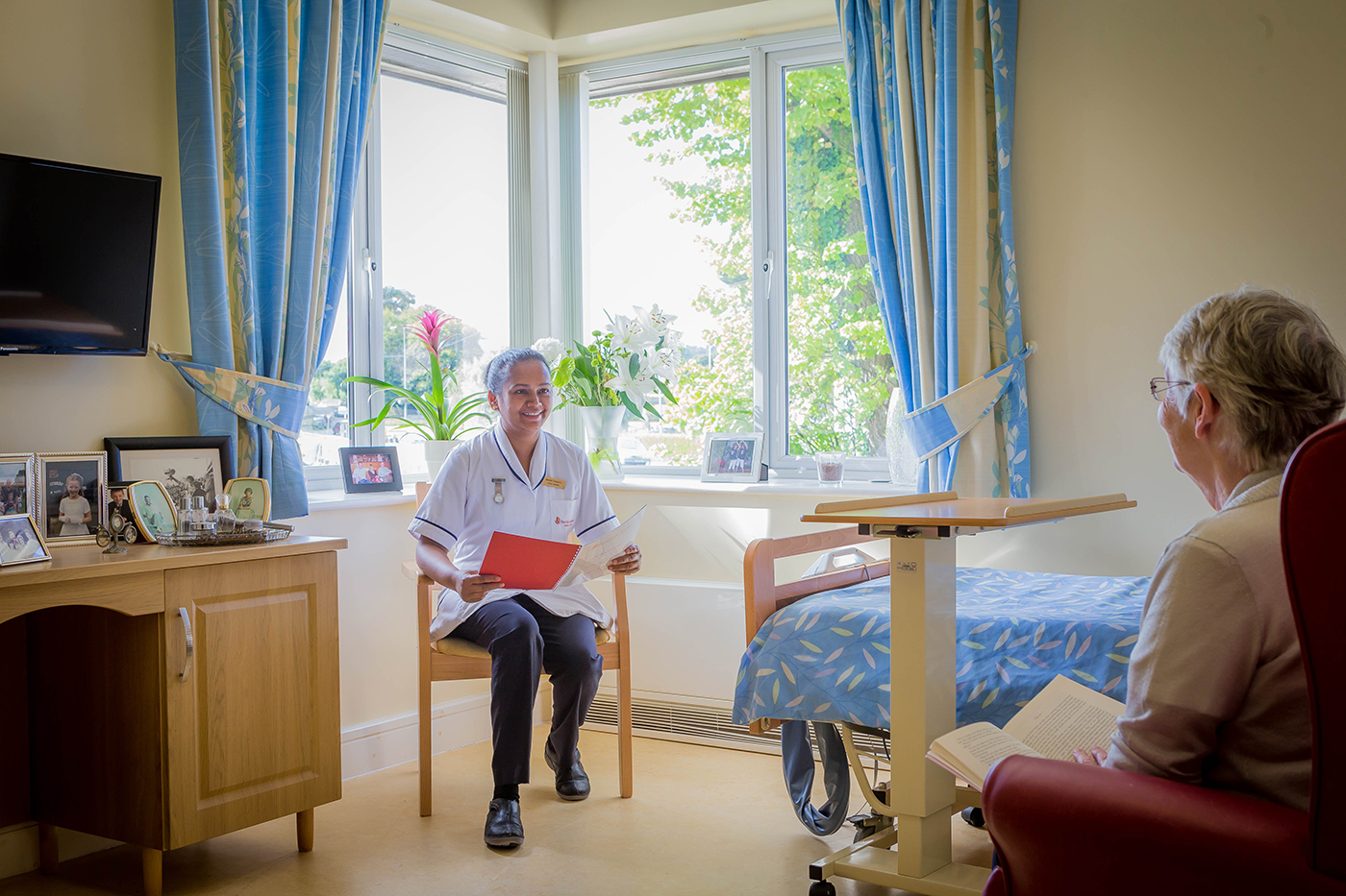 Nurse Sitting with Resident in Bedroom © David Cantwell Photography