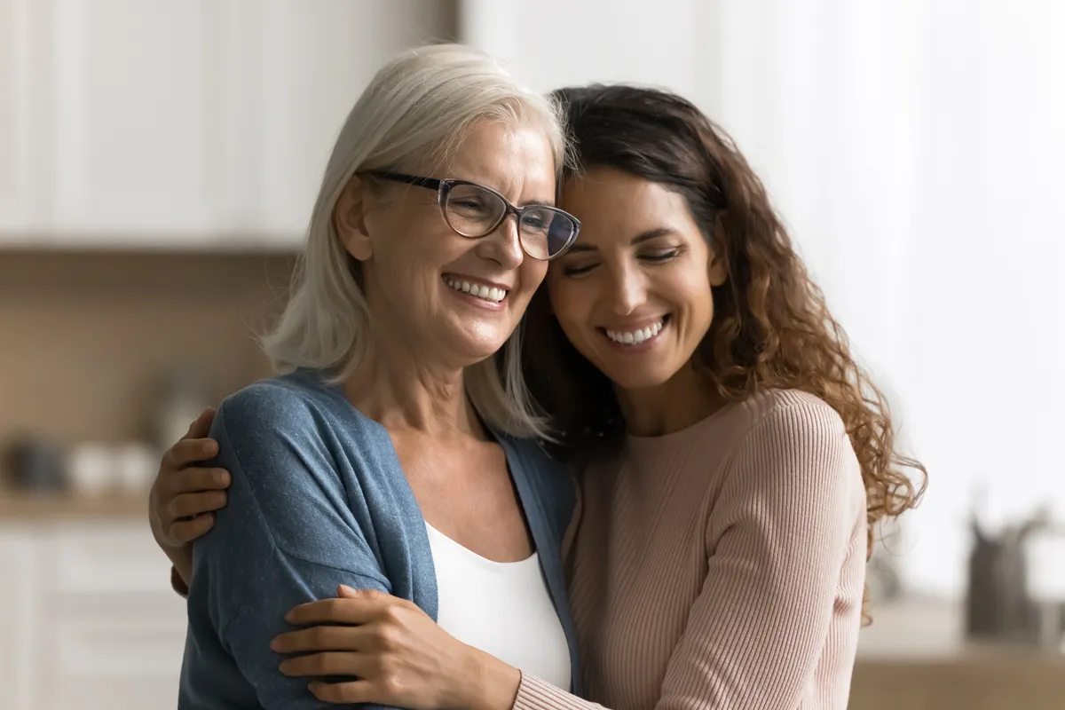 Women and daughter smiling.