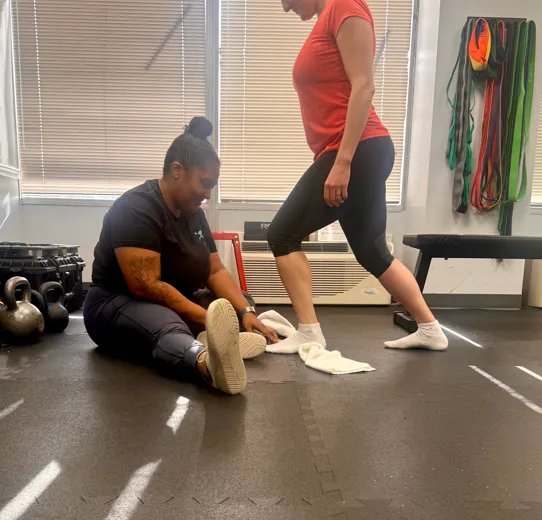 Athlete undergoing a functional movement assessment with a physical therapist at a sports physical therapy clinic in Riverdale, MD