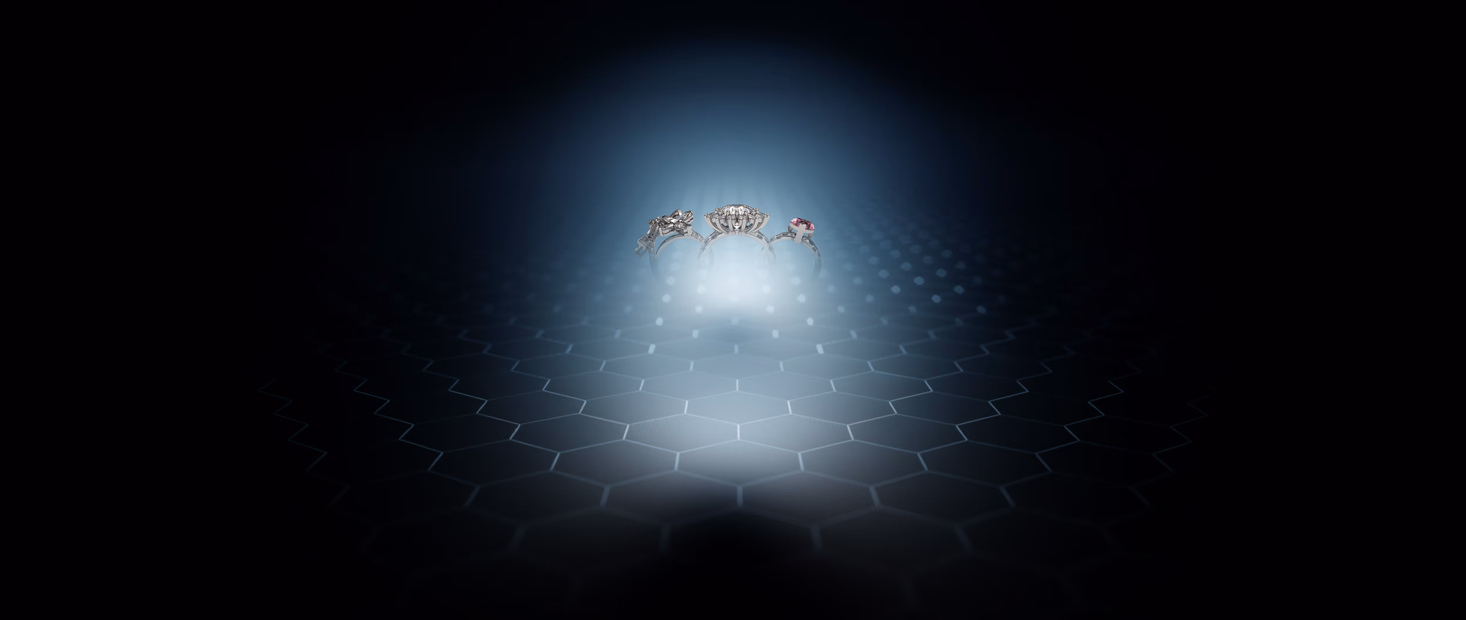 Three silver rings with different gemstones glowing on a dark hexagonal patterned surface.