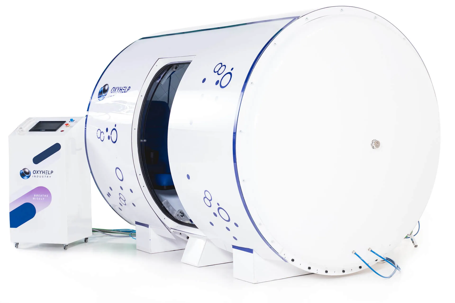 White cylindrical hyperbaric oxygen therapy chamber with open door next to a control unit labeled OXYHELP INDUSTRY.