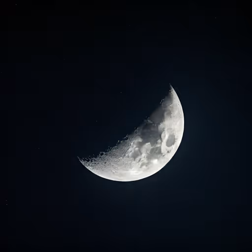 Crescent moon in high resolution detail against a velvety black sky with subtle star clusters