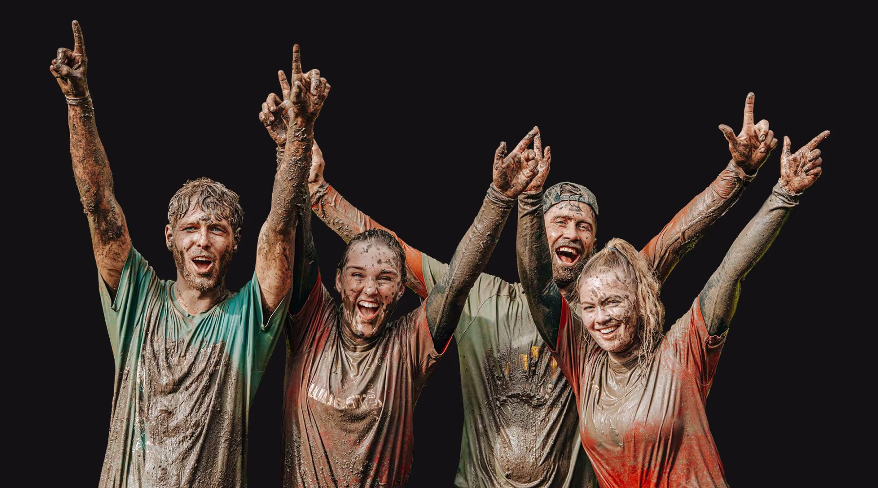 Cheering group of muddy participants