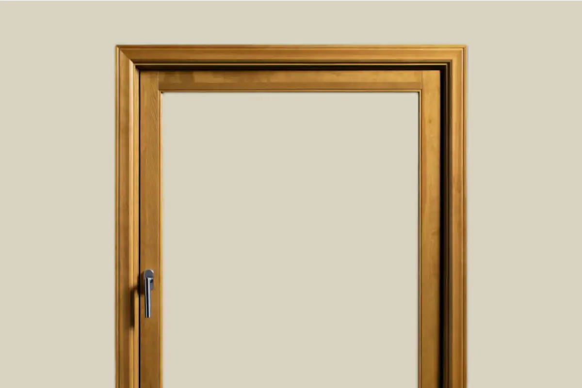 Wooden tilt-and-turn window frame with black handle on beige background.