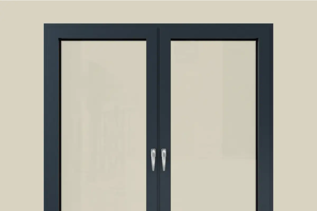Black aluminum double window with silver handles set in a beige wall.