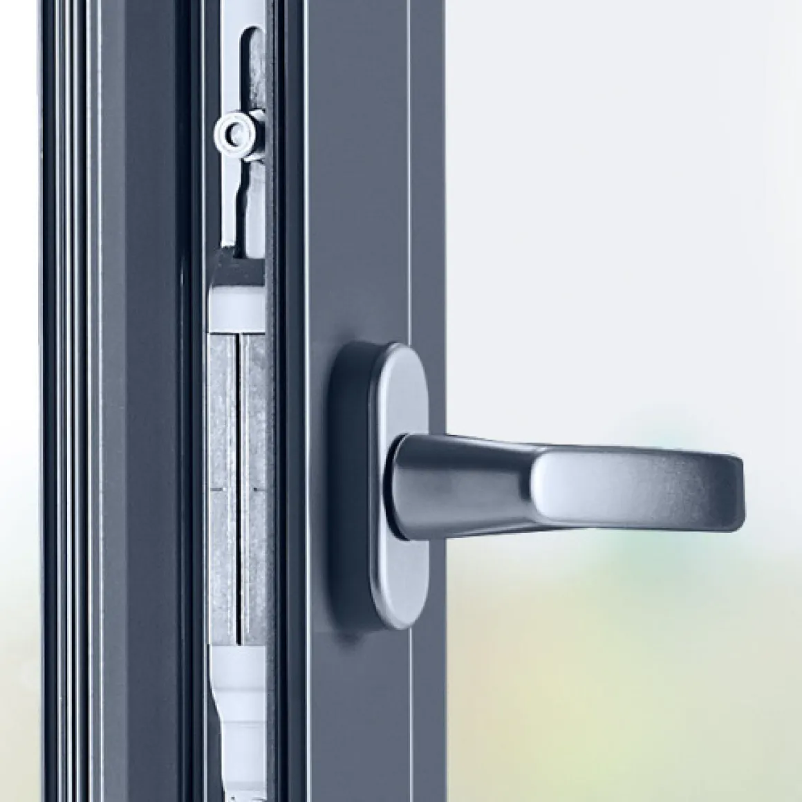 Close-up of a modern metal door handle on a dark-colored door frame with visible locking mechanism.