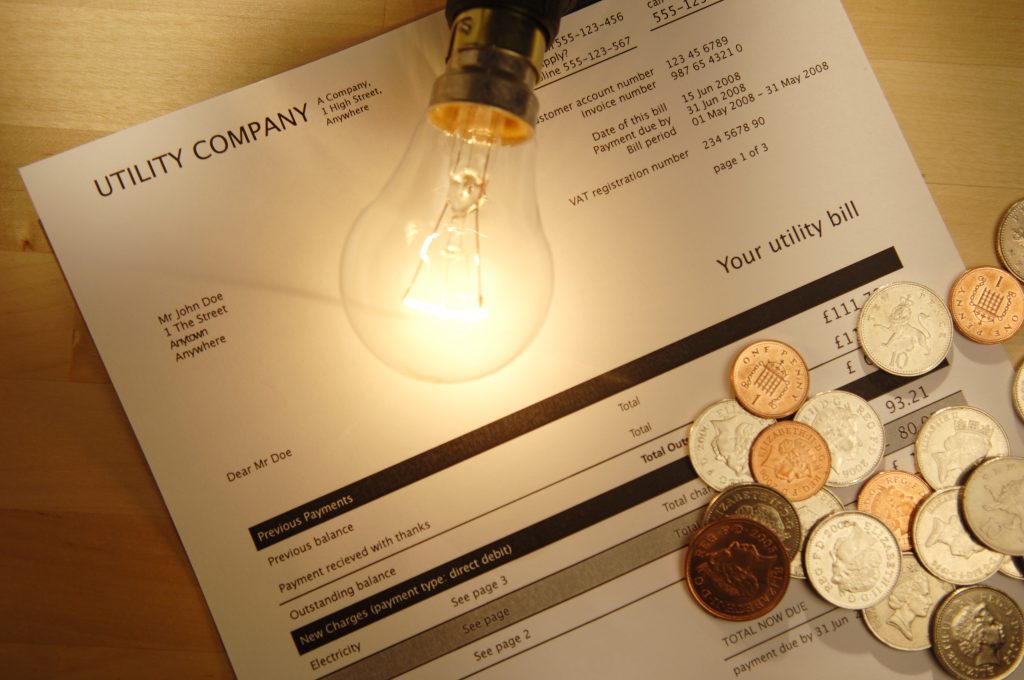 Utility bill with lightbulb and coins