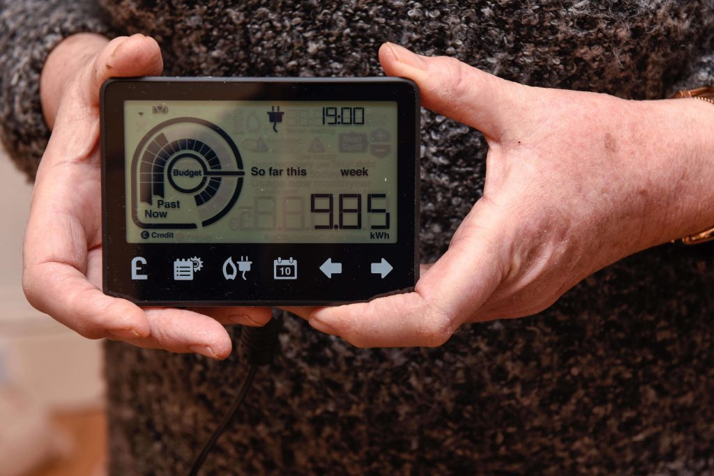 a person holding a smart energy meter