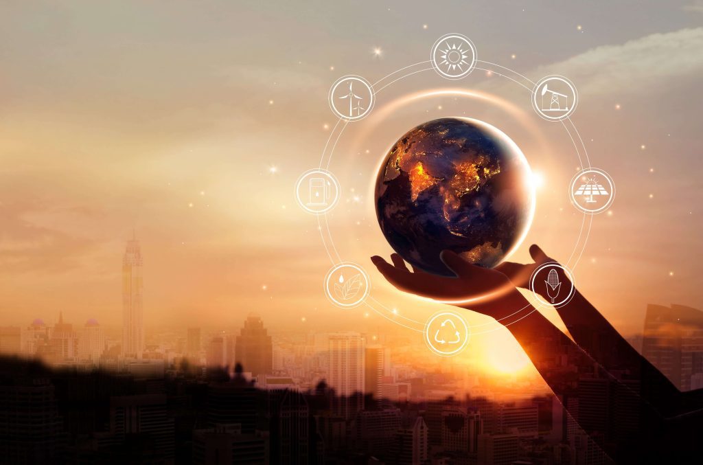 hands holding up a globe with energy icons surrounding it.