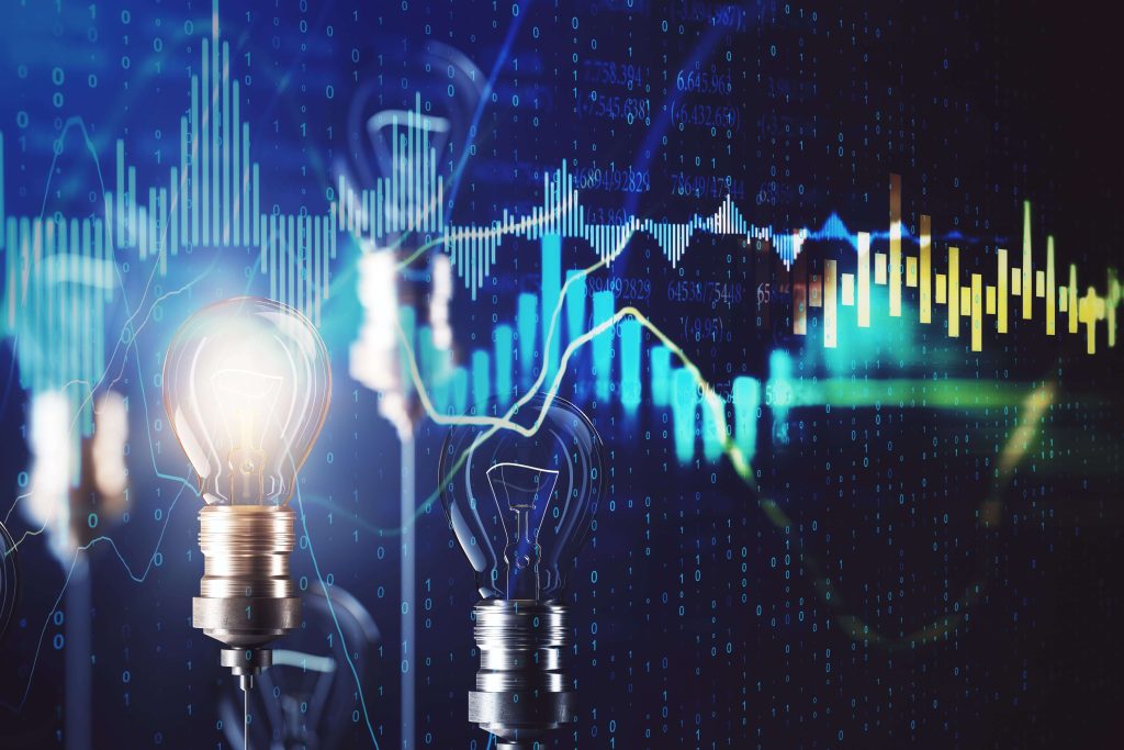 Two lightbulbs in front of numbers and data
