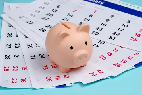 calendars with a piggy bank on top