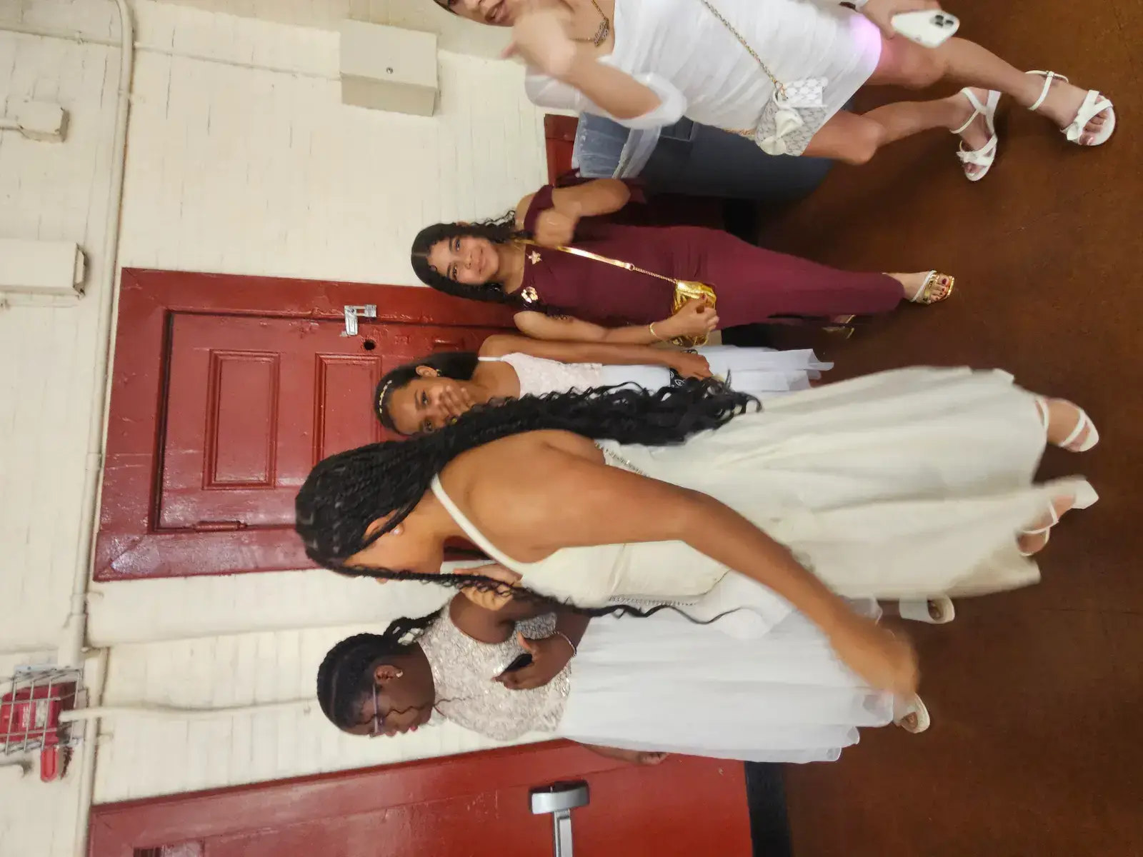 Students dressed in formal attire posing together at senior prom