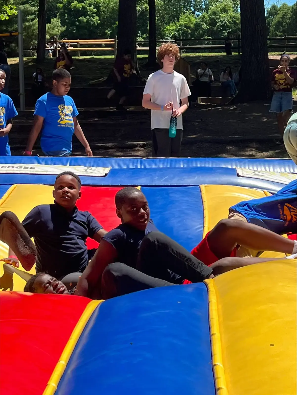 Students playing on inflatable bounce structure during senior trip