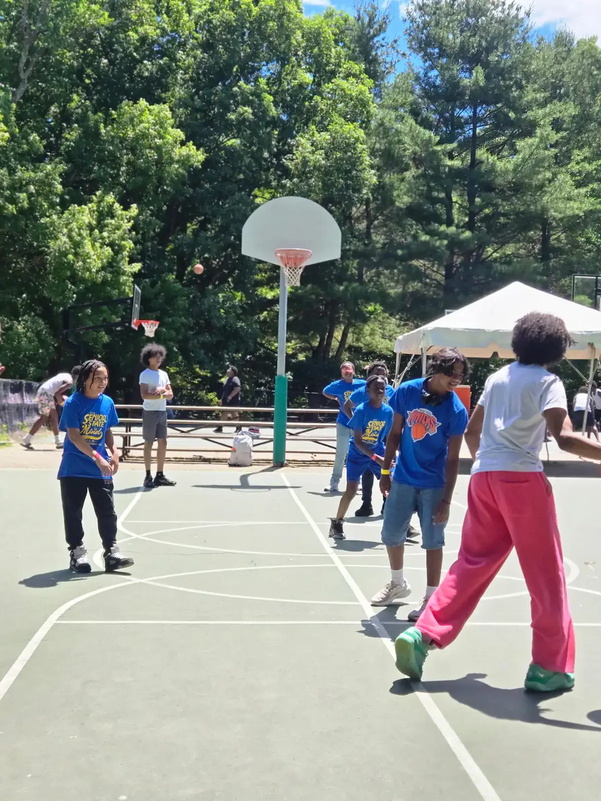 Students playing basketball outdoors during a school senior trip