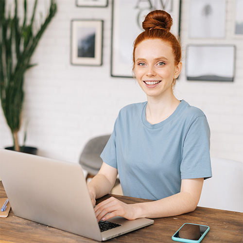 Woman at a desk with a laptop