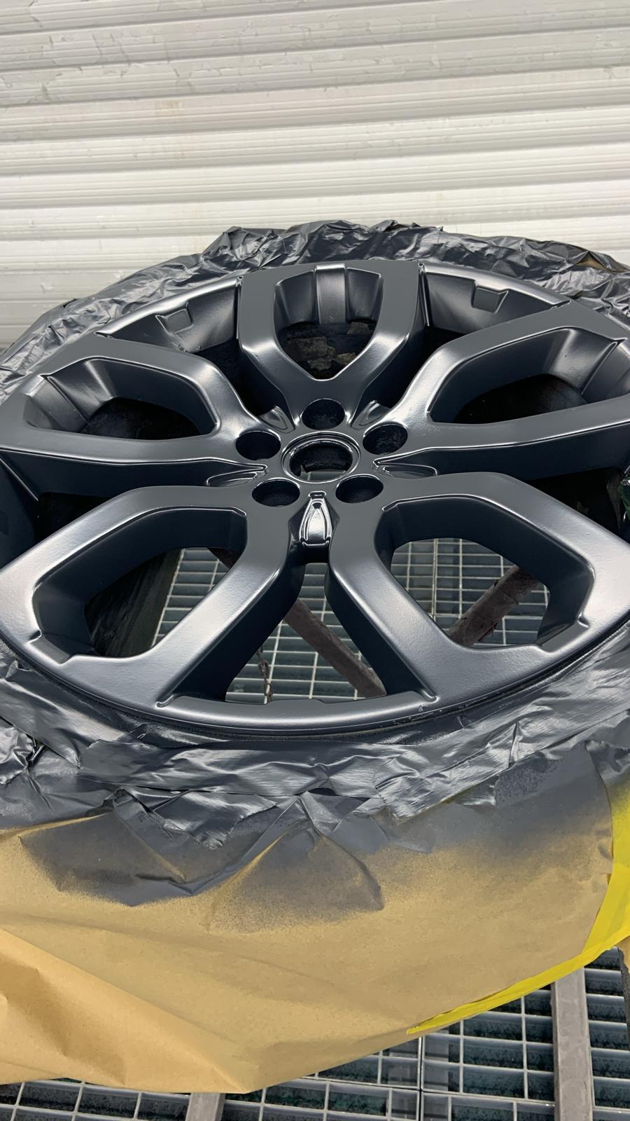 Alloy wheel refinished in anthracite grey, masked up in the Stanways paint shop
