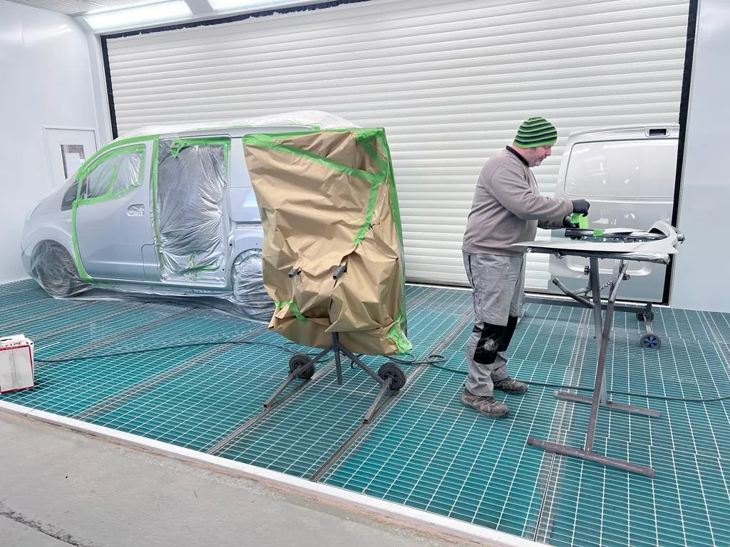 Van masked up for refinishing in the spray booth