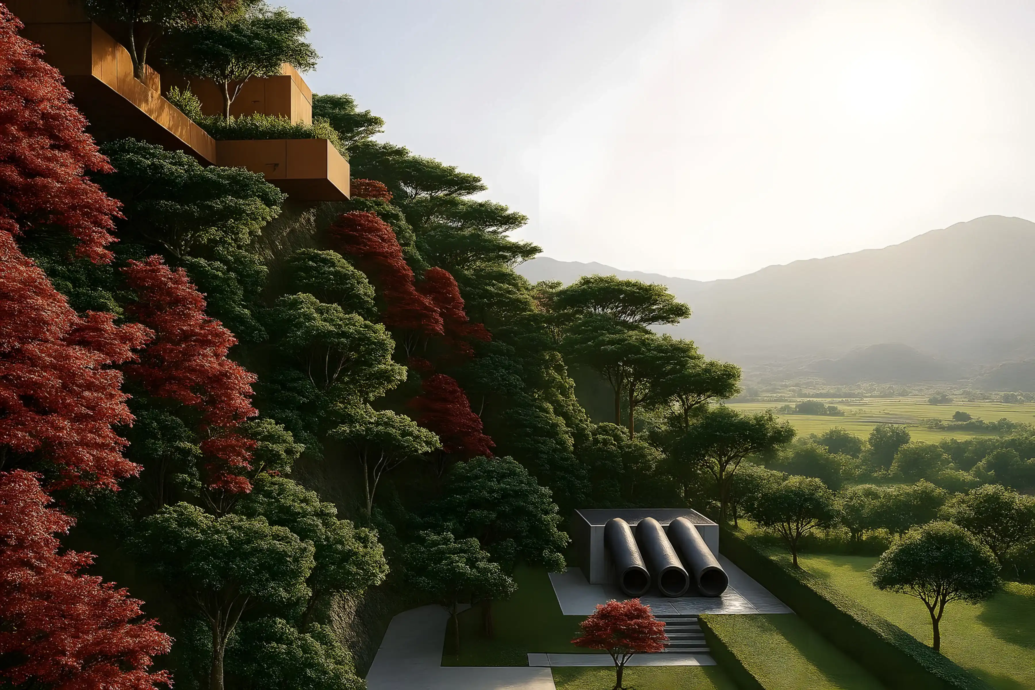 Edificio moderno en voladizo sobre una ladera con árboles rojos y verdes, y tres grandes tubos negros en un patio bajo, con paisaje de montañas y campo al fondo.