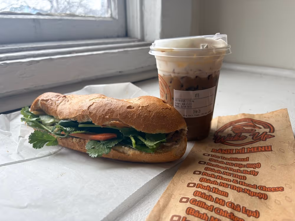 A sandwich and a cup of coffee on a table.