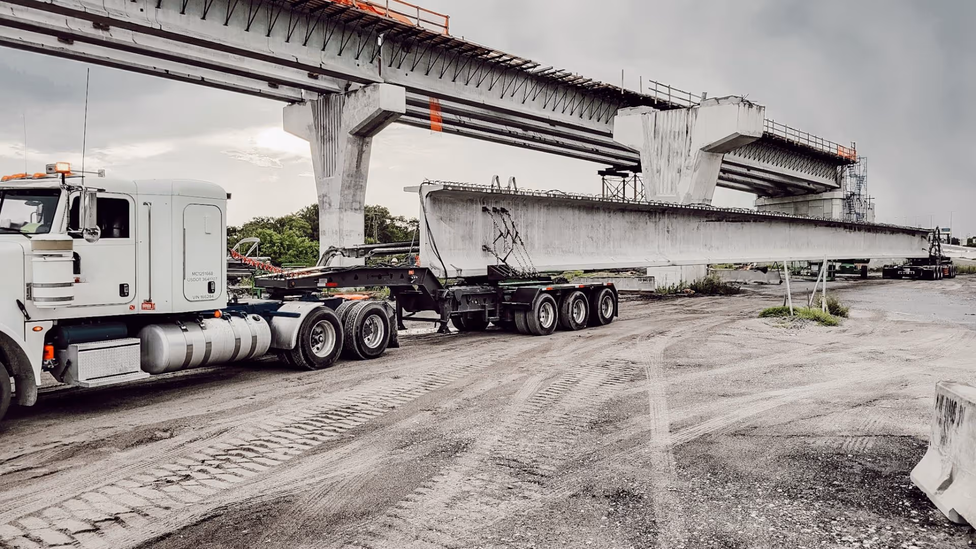 [background image] image of a transport fleet parking area (for a trucking company)