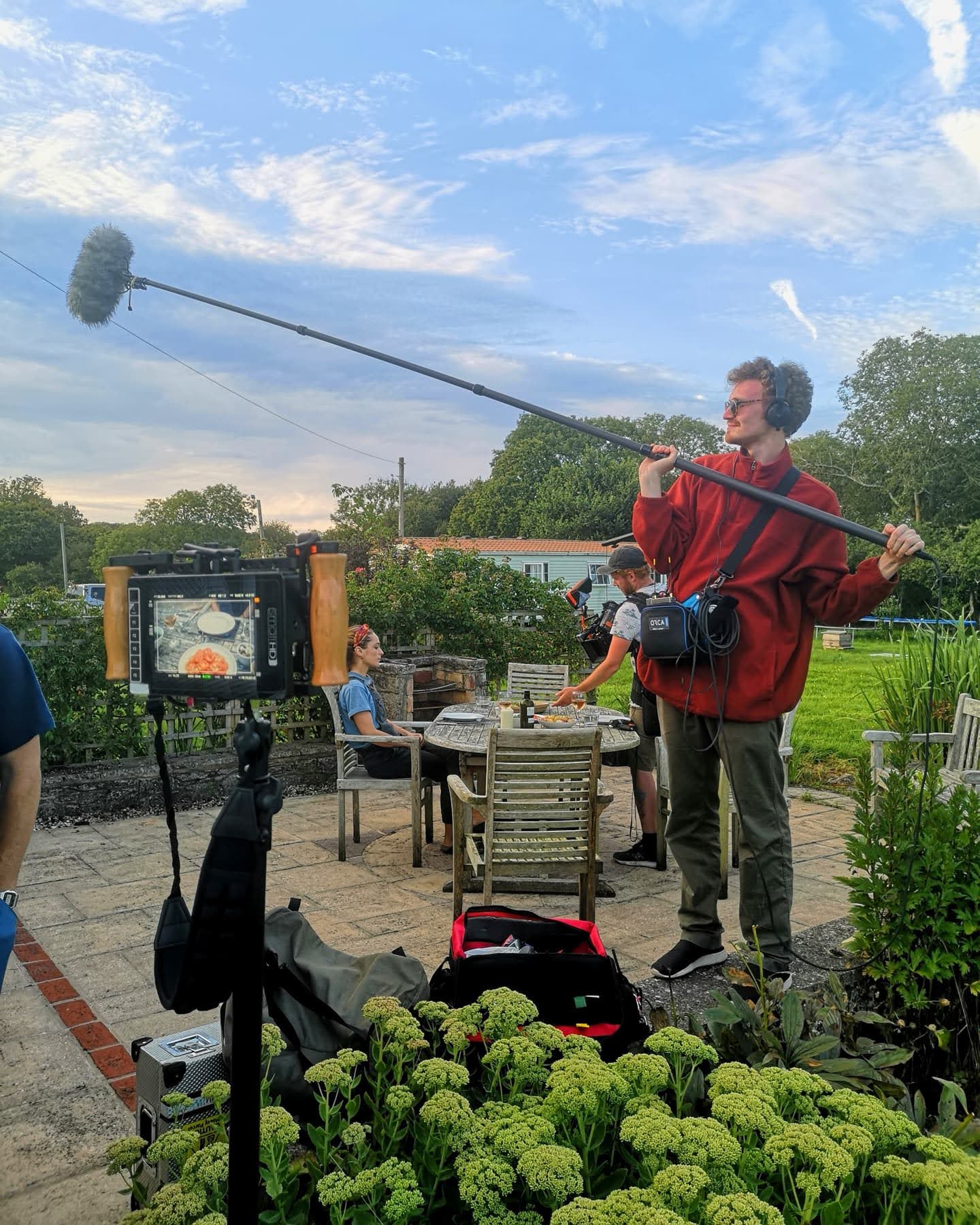 Film crew on set with mic boom.