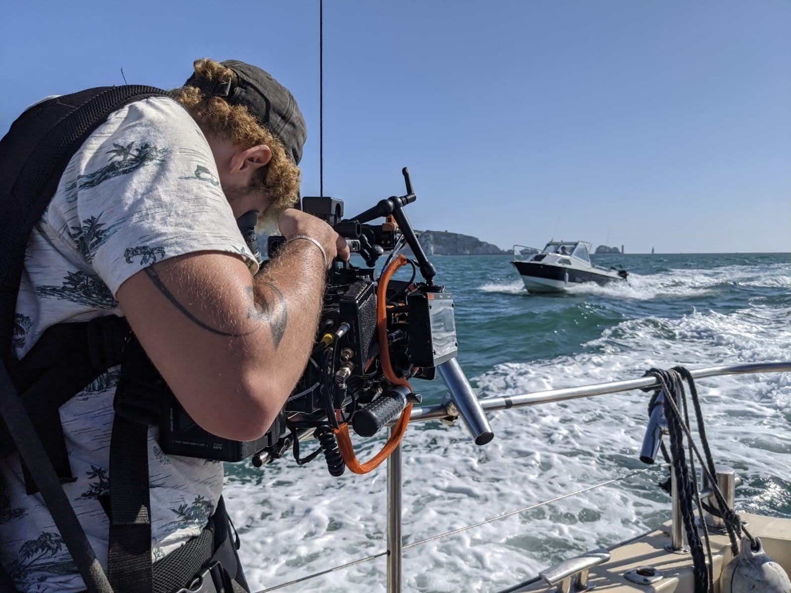 Film crew filming boat.