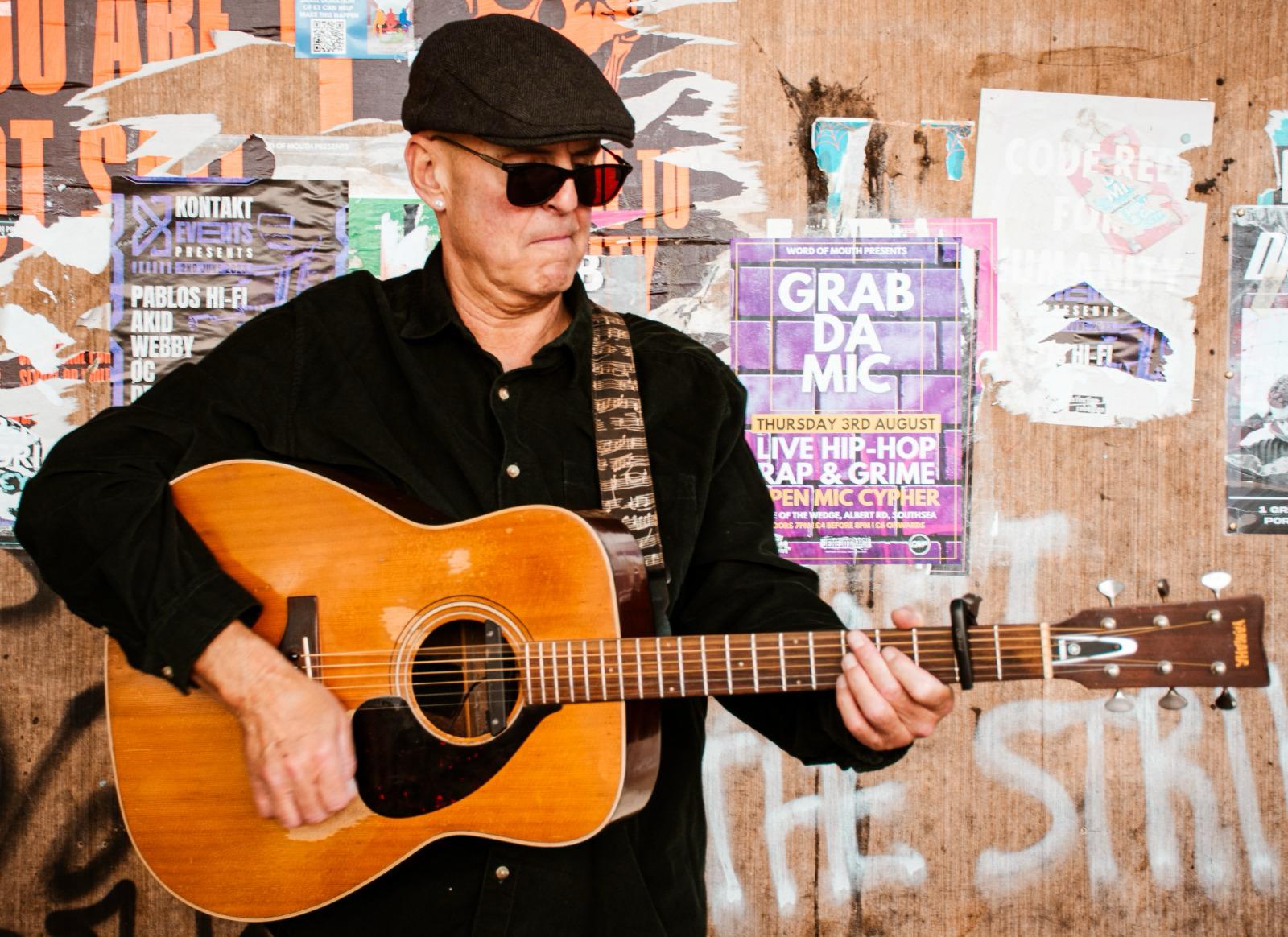 John Wroath playing guitar.