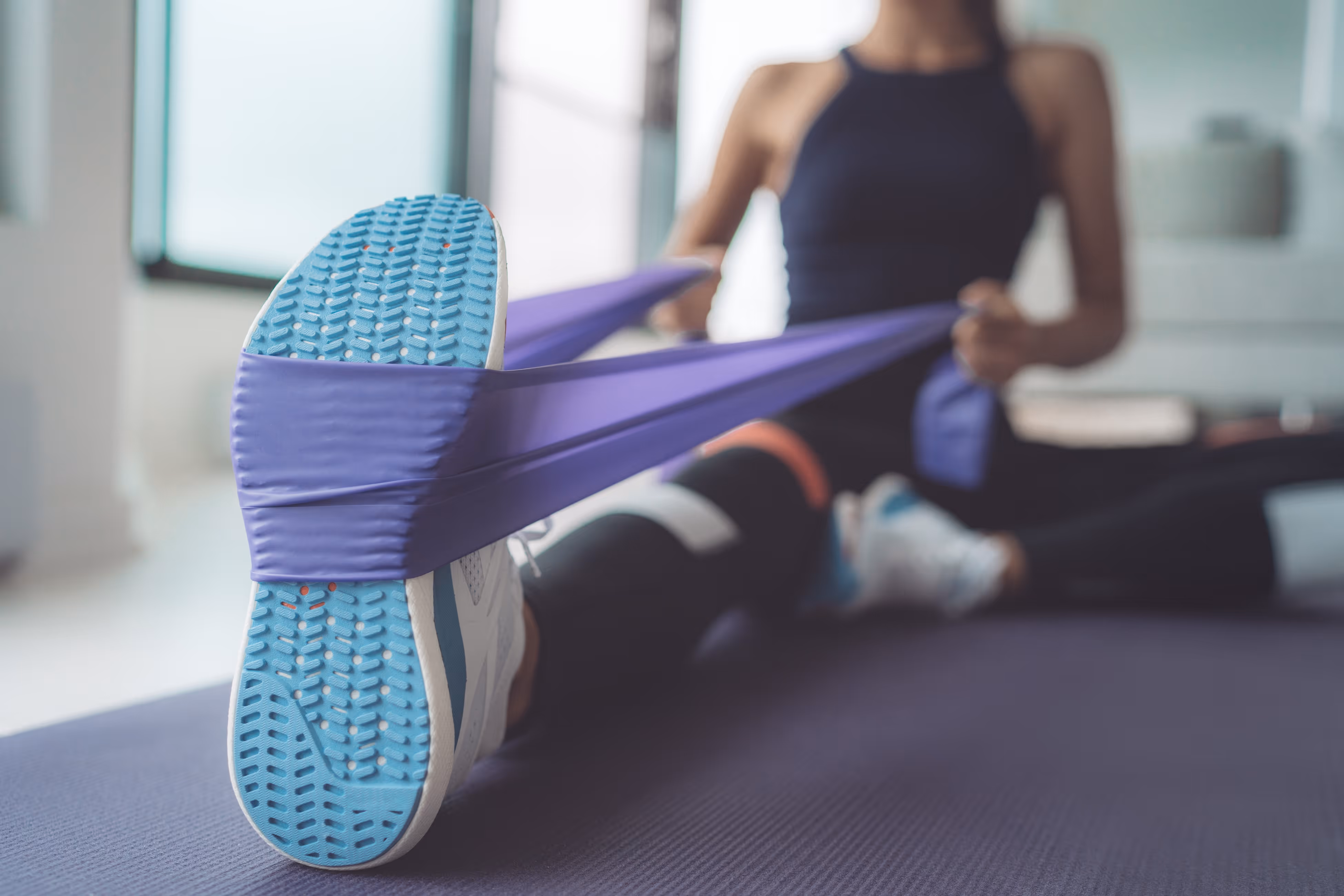 Woman stretching foot with a band stock image