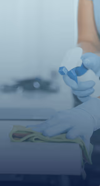 Office cleaning technician sanitizing workspace - EMERIH Cleaning Services Bergen County NJ