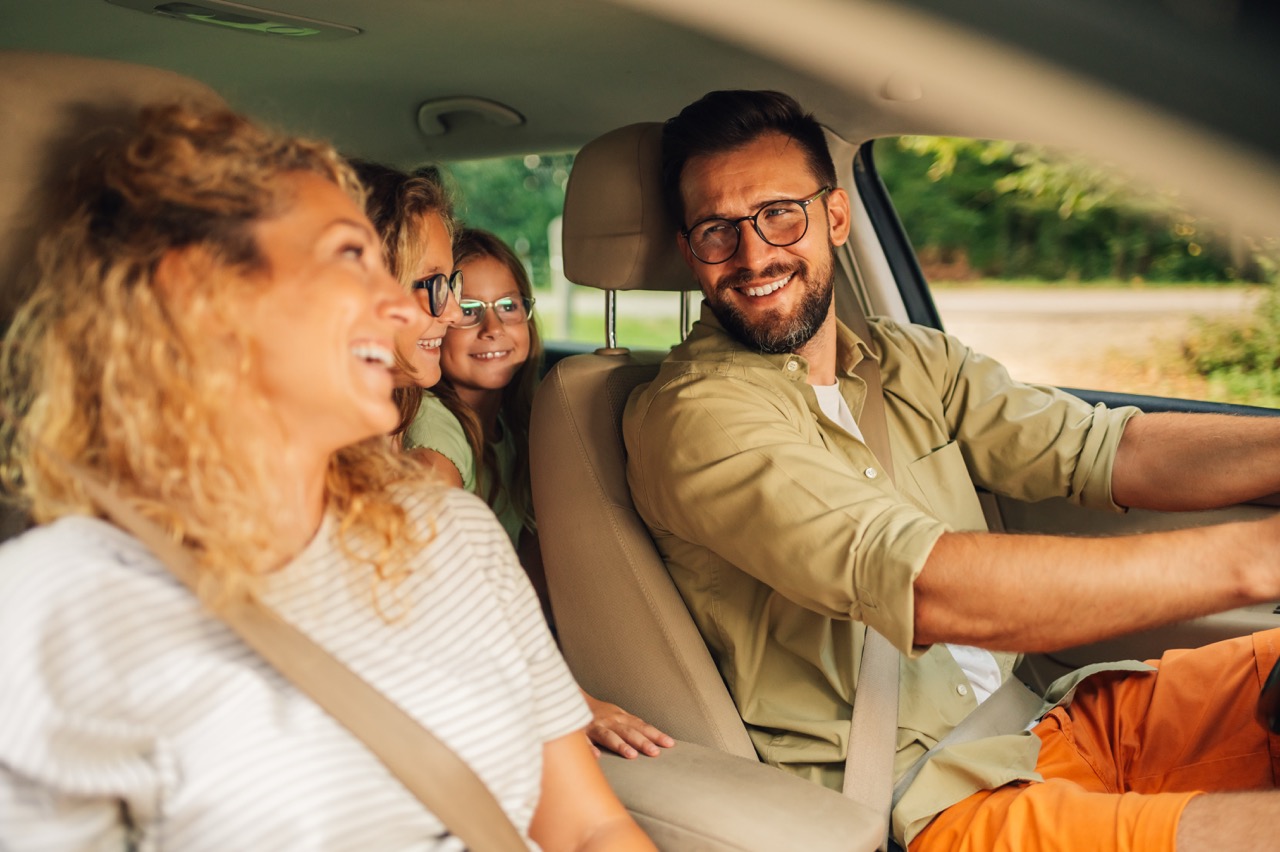 Happy family traveling together in a car