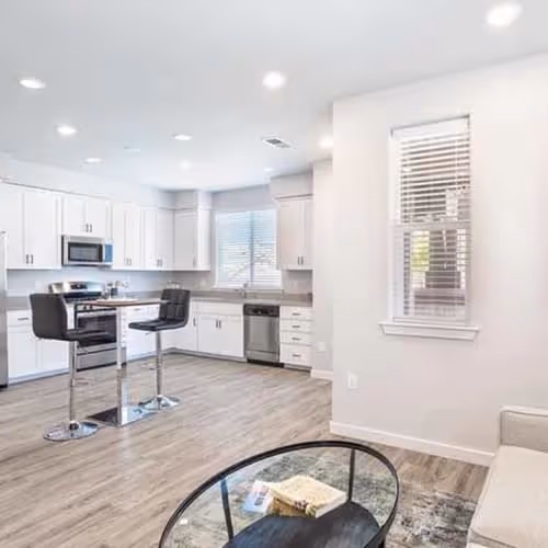 Kitchen with island, white cabinets, and stainless steel appliances