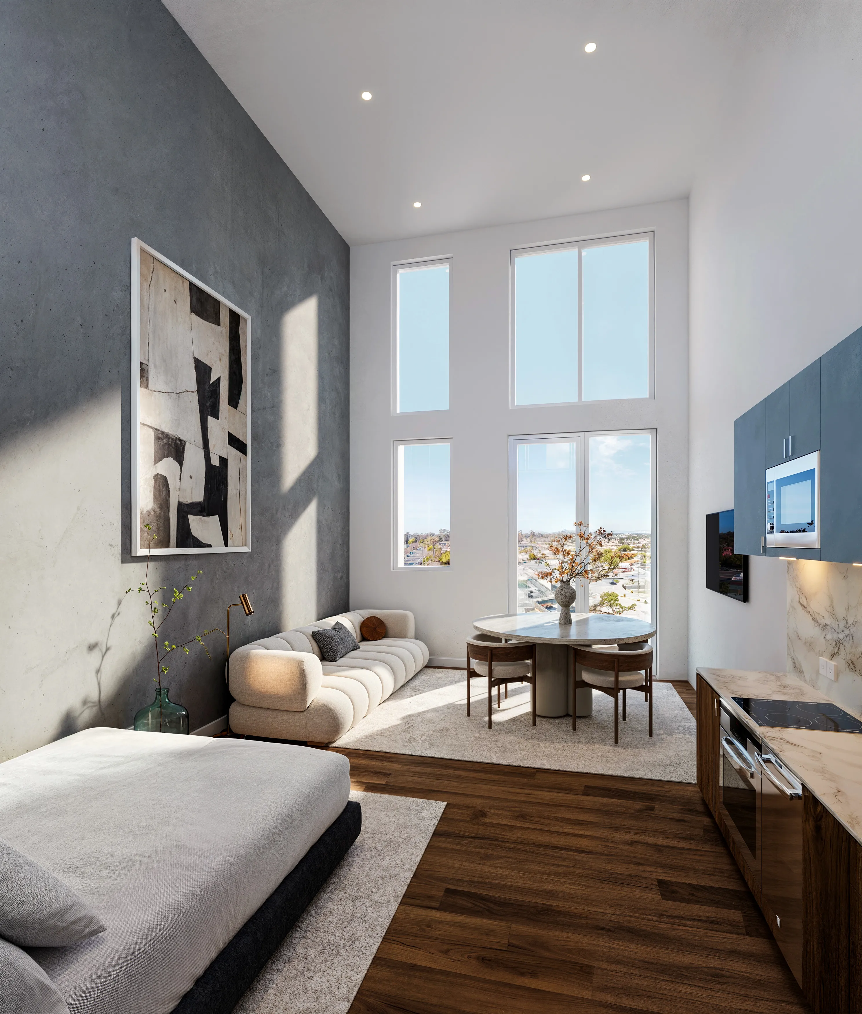 Modern apartment interior with a bed, beige sofa, round dining table with chairs, large windows, and a compact kitchen area.