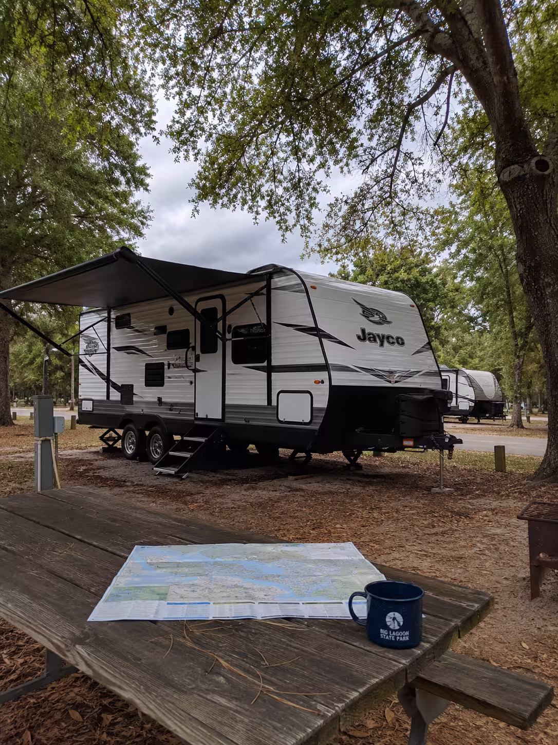 Camper under shade trees at Big Lagoon State Park Pensacola