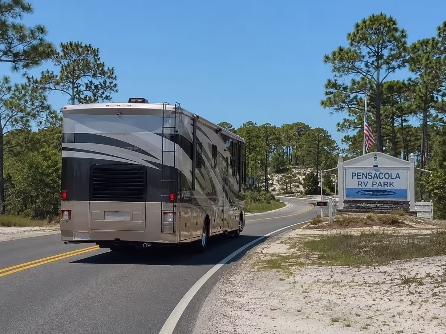Class A motorhome driving toward a Pensacola RV park