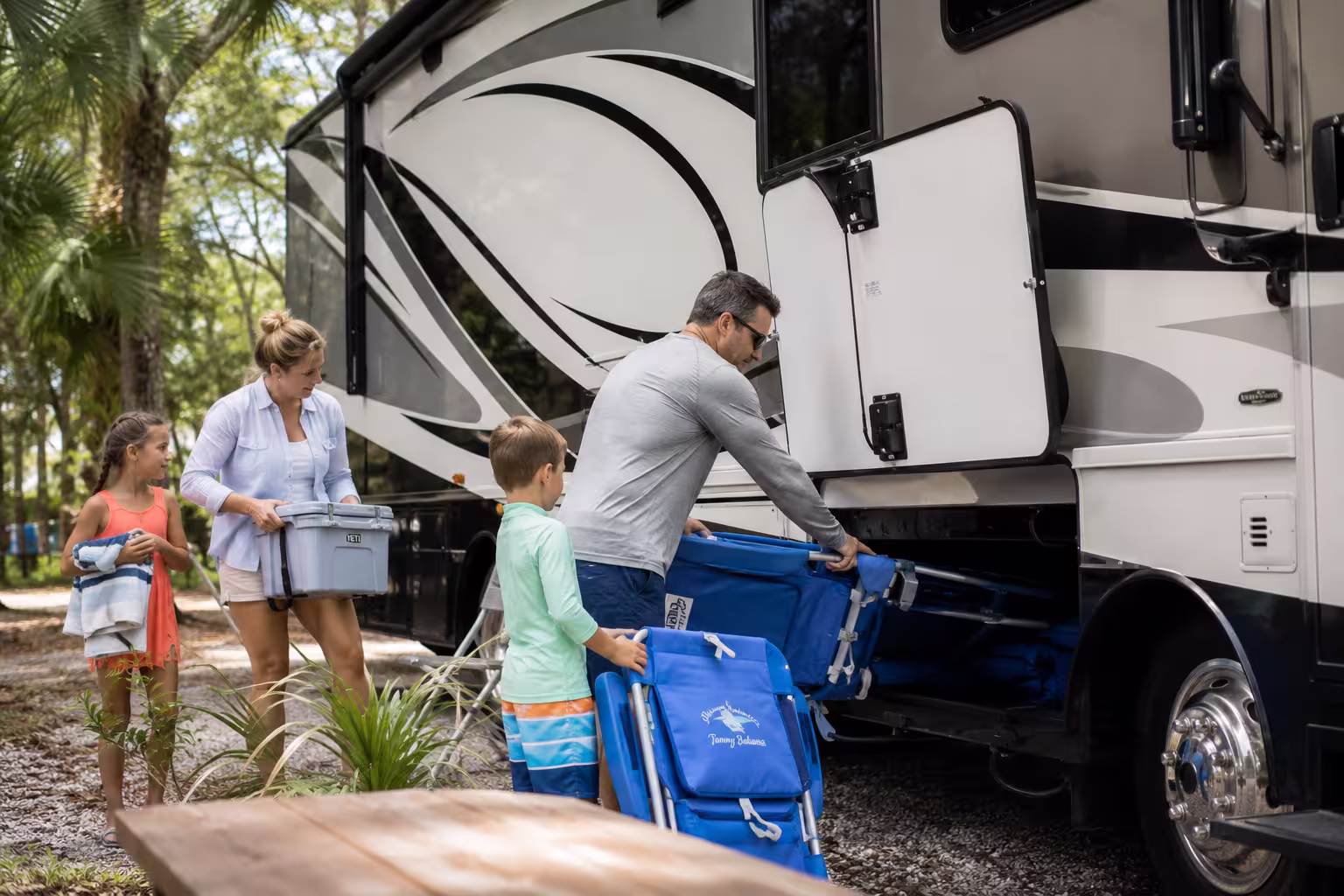 Family loading gear into a Class A motorhome in Pensacola