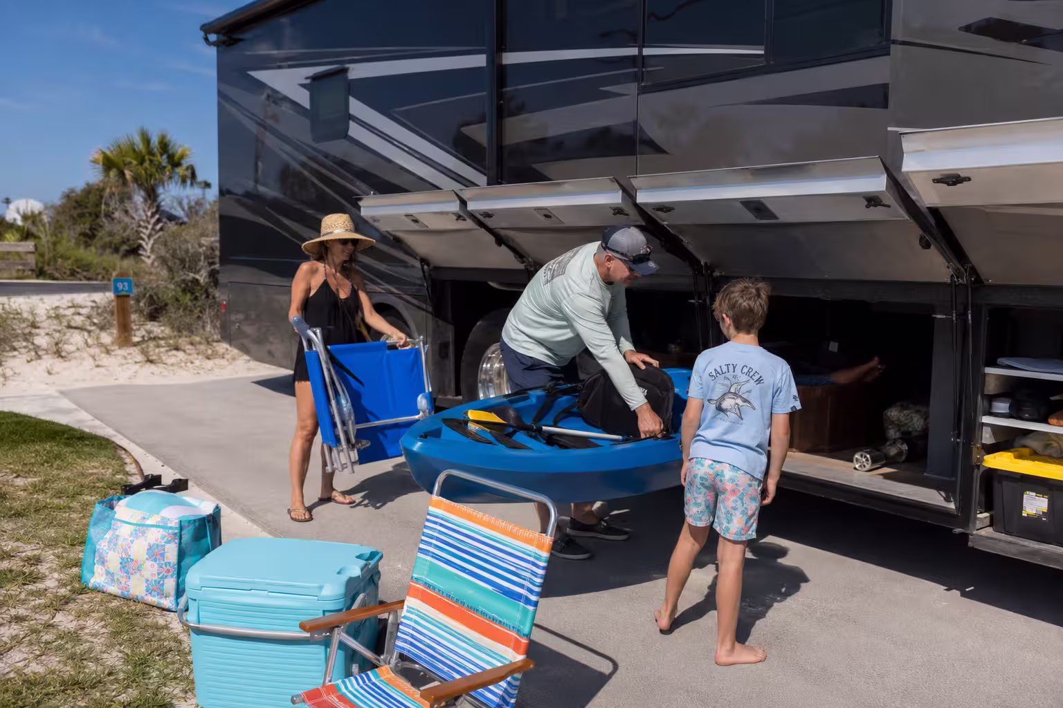 Family loading gear into a luxury RV near Perdido Key