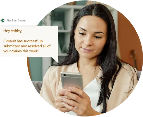 Woman looking at her smartphone, with a message about claim submissions.