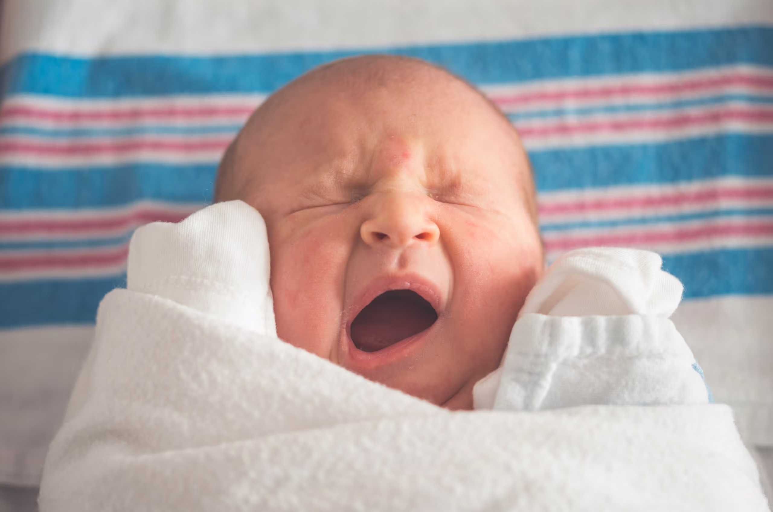 A newborn, yawning.