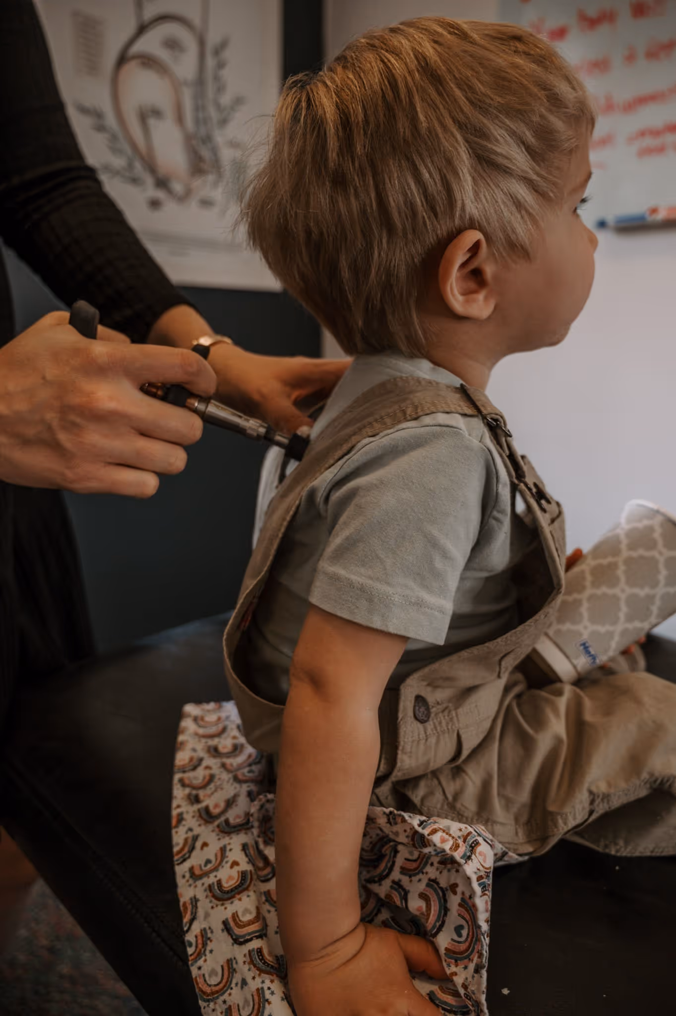 A toddler receiving chiropractic care.