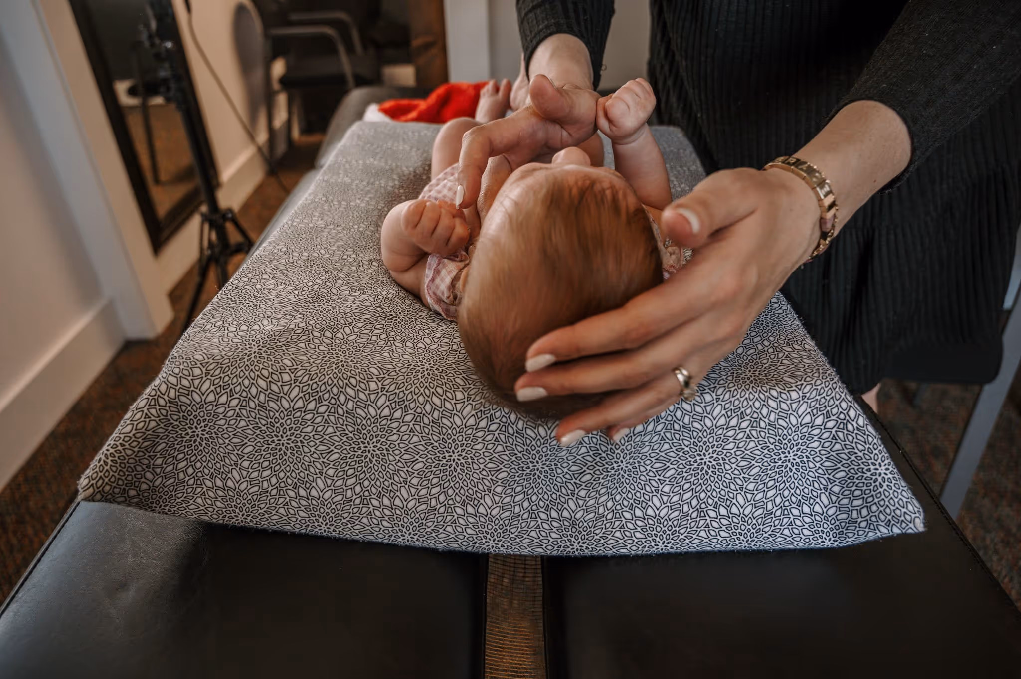 A newborn receiving chiropractic care.