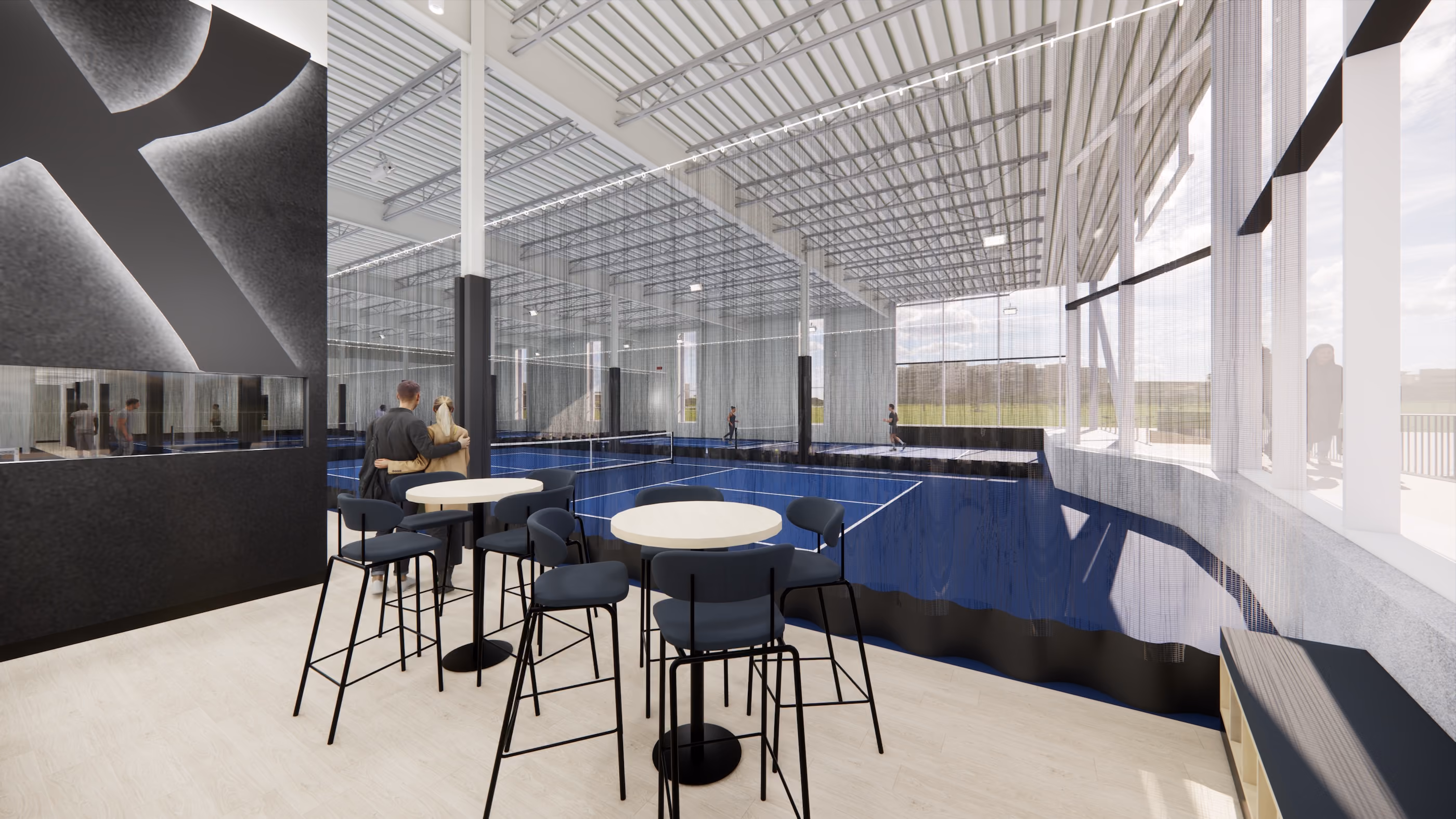 Modern indoor seating area with round tables and high chairs overlooking a blue sports court with players.