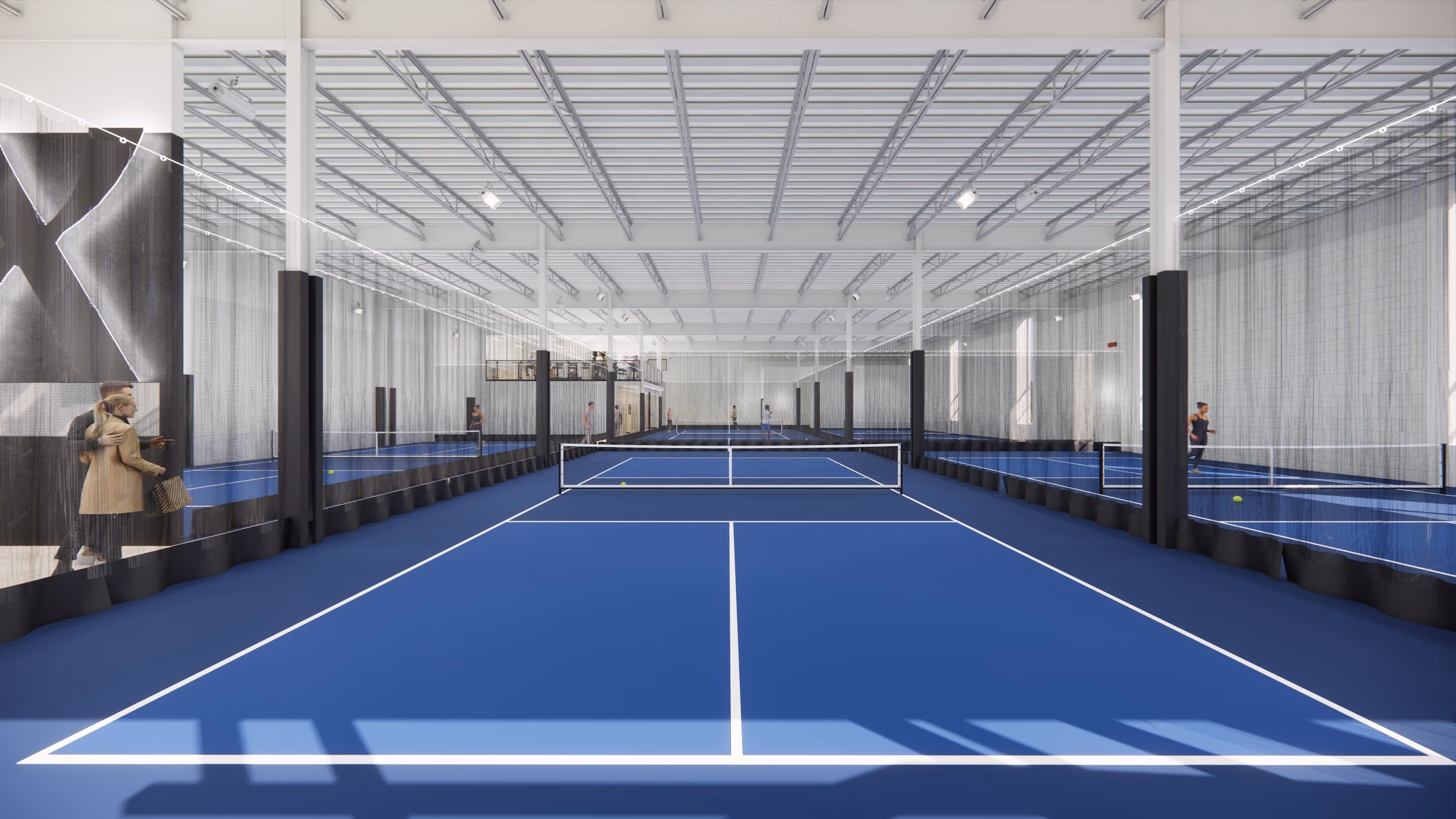Indoor blue tennis courts separated by nets and transparent curtains with players and spectators visible.