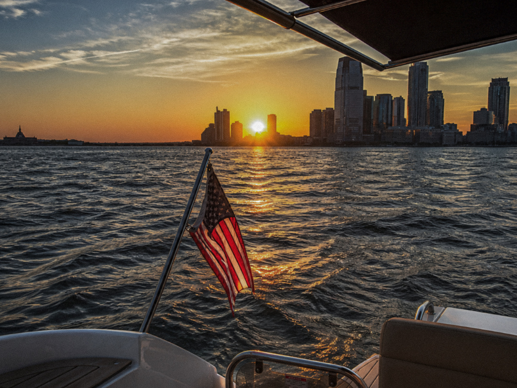 Corporate yacht charter on New York Harbor - Manhattan skyline at golden hour