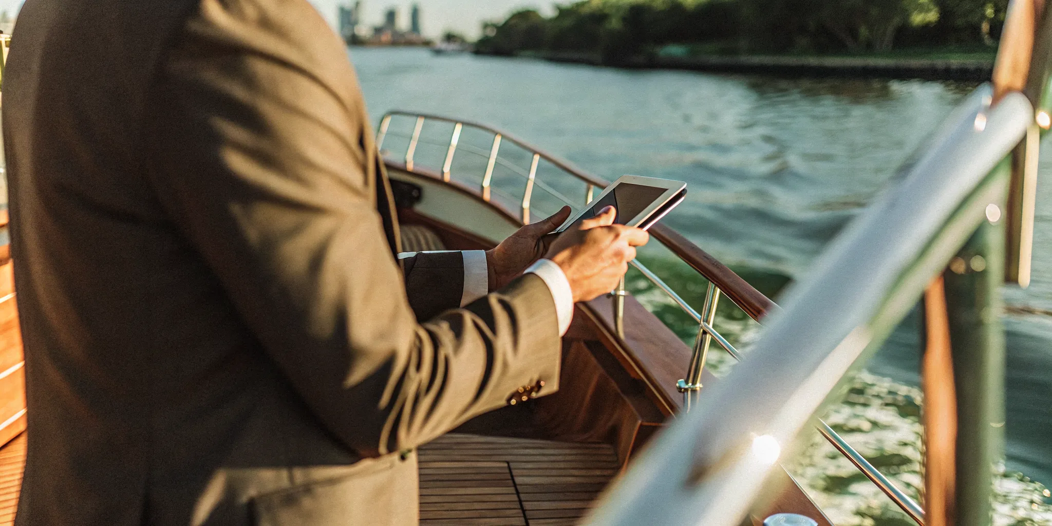 Corporate event cruise in NYC with a professional using a tablet on a yacht.