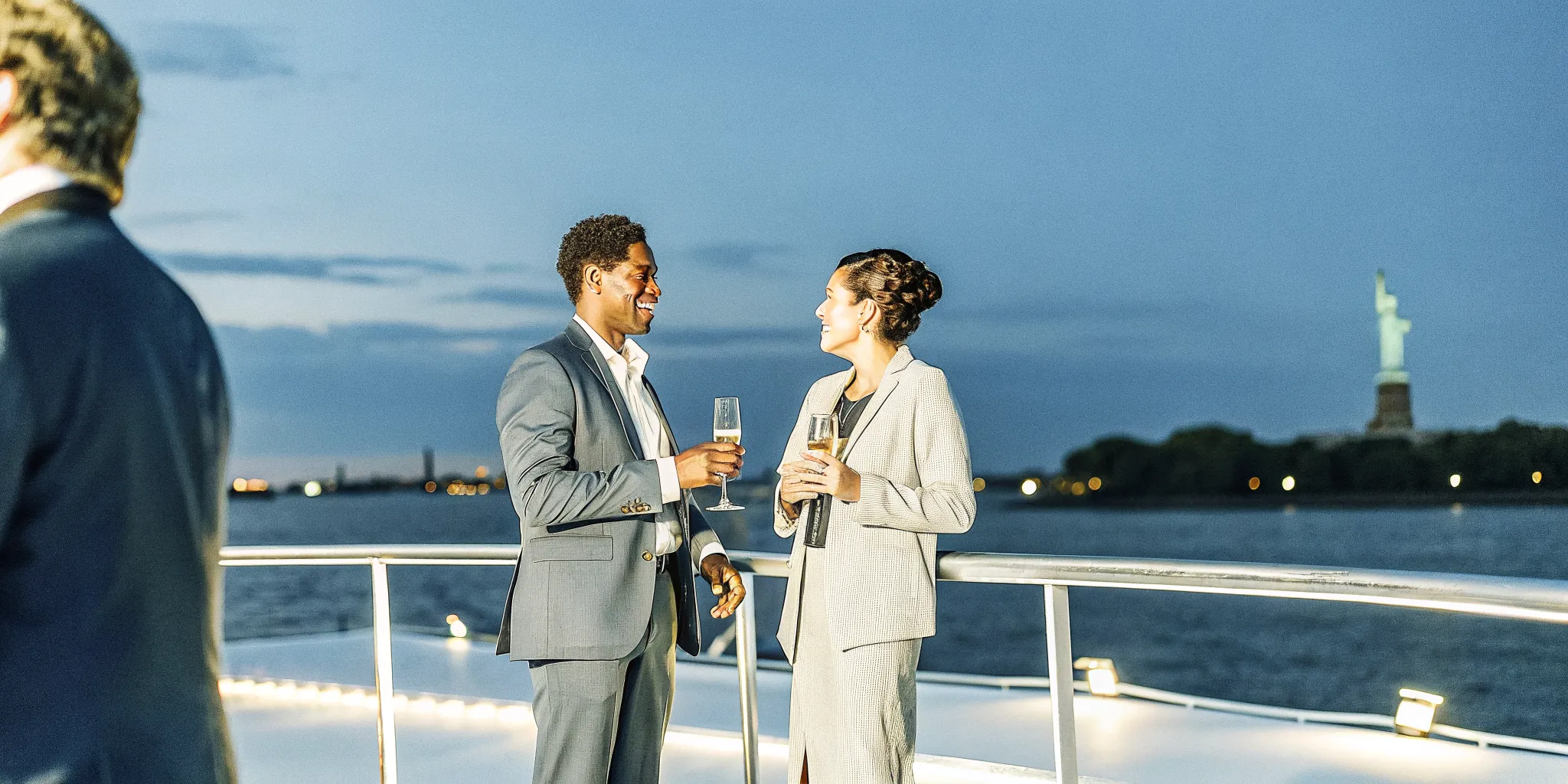 Private yacht corporate networking event on New York Harbor with the Manhattan skyline at dusk