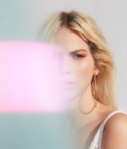 Smiling bald man with glasses and a red beard wearing a gray sweater.