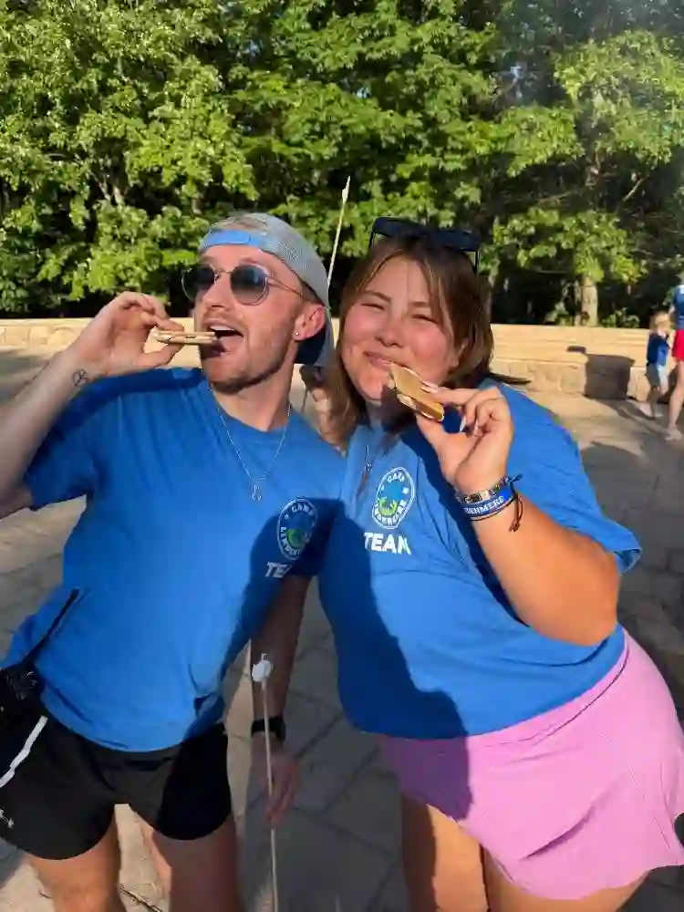 Friends eating s'mores at Summer Camp