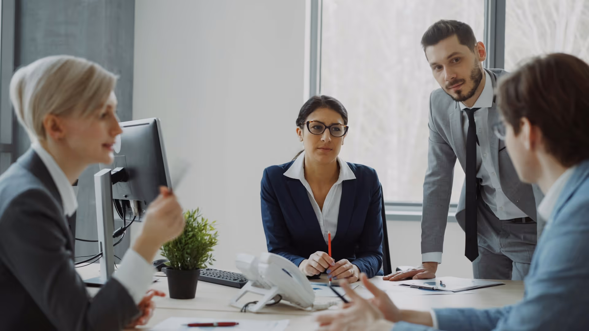Business professionals collaborating in a modern office meeting discussing strategy